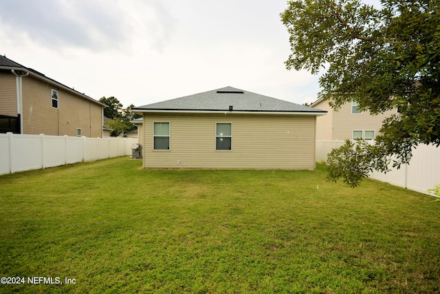 back of property featuring a lawn