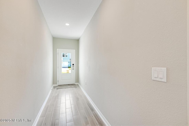 hall with hardwood / wood-style floors