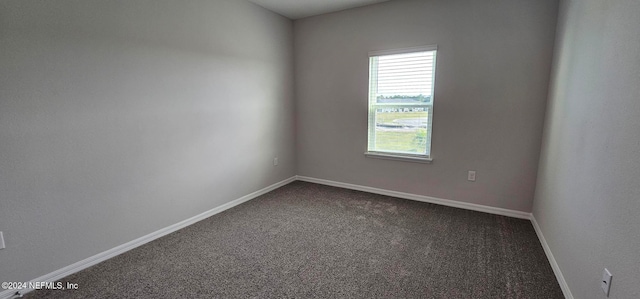 empty room with dark colored carpet