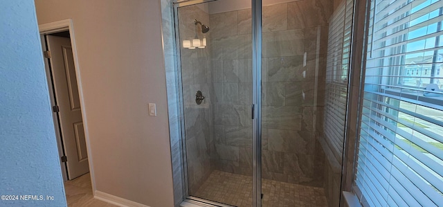 bathroom with a shower with shower door