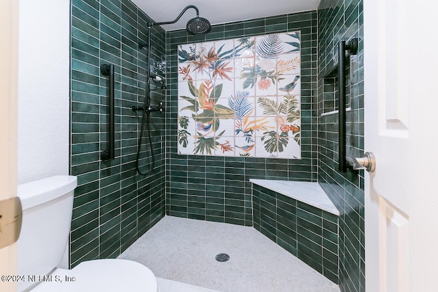 bathroom with a tile shower and toilet