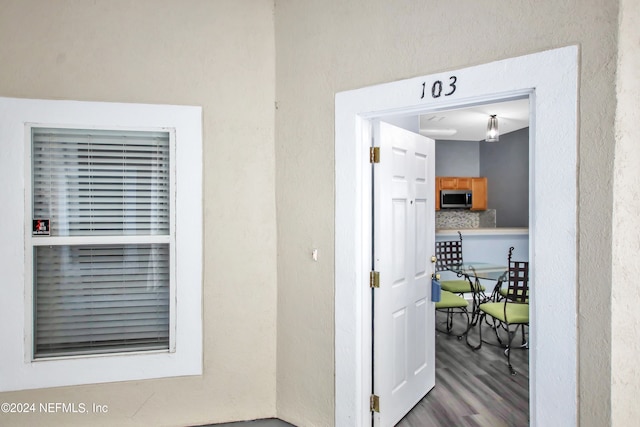 corridor with hardwood / wood-style flooring