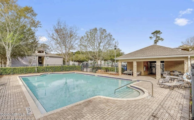 view of swimming pool featuring a patio area