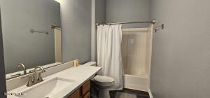 full bathroom with vanity, toilet, and shower / bathtub combination with curtain