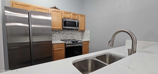 kitchen with decorative backsplash, stainless steel appliances, and sink