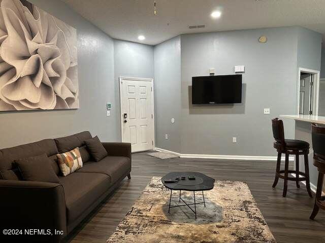 living room with dark hardwood / wood-style floors