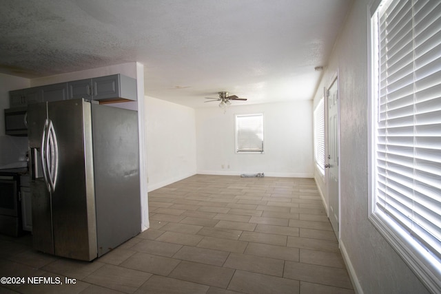 kitchen featuring range with electric stovetop, gray cabinetry, a textured ceiling, stainless steel refrigerator with ice dispenser, and ceiling fan