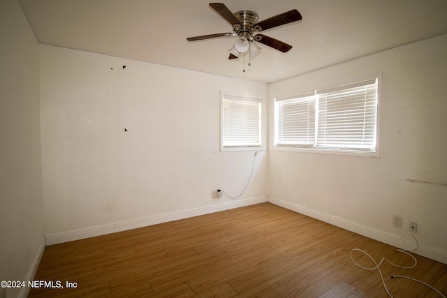 unfurnished room with ceiling fan and wood-type flooring