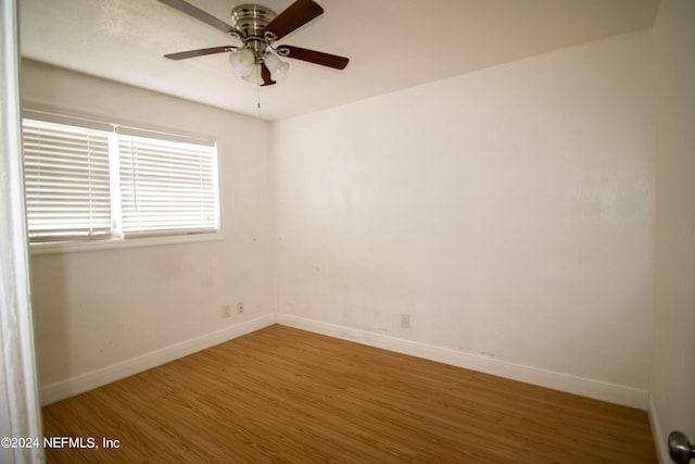 unfurnished room featuring ceiling fan and hardwood / wood-style floors