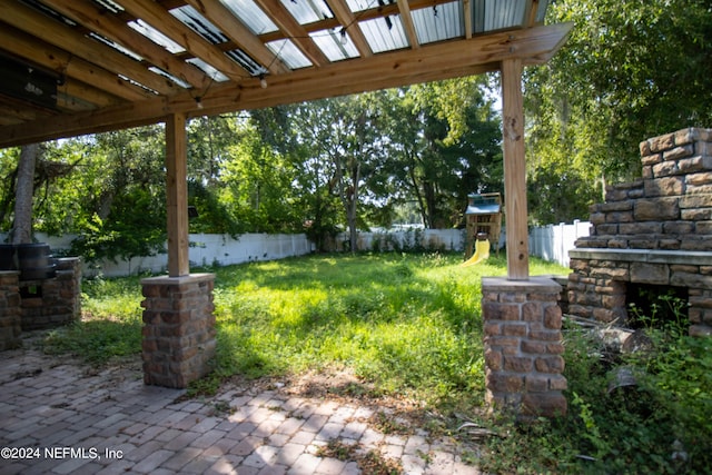 view of yard featuring a patio and a playground