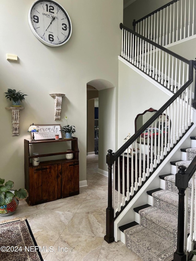 stairway with a towering ceiling