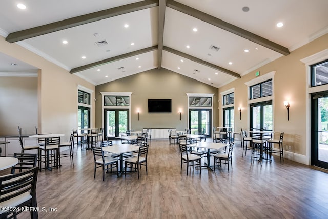 dining space with french doors, light hardwood / wood-style floors, beam ceiling, and a wealth of natural light