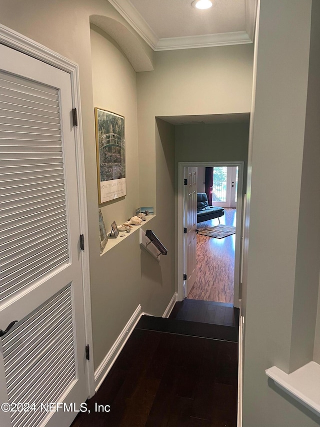 hall with hardwood / wood-style flooring and crown molding