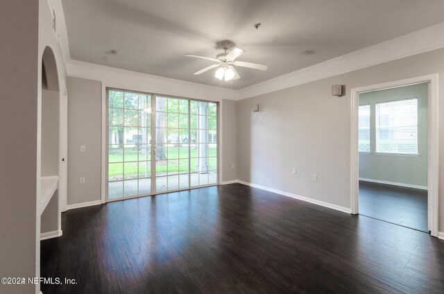 empty room featuring ornamental molding, dark hardwood / wood-style floors, and ceiling fan