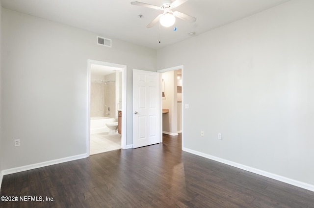 spare room with visible vents, ceiling fan, baseboards, and wood finished floors