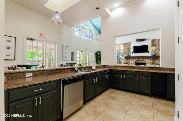 kitchen featuring a ceiling fan, dishwasher, a high ceiling, a sink, and light tile patterned flooring