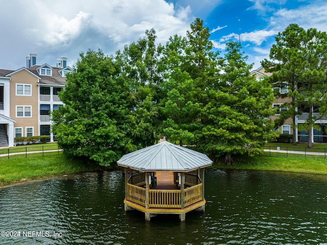 view of dock featuring a water view and fence