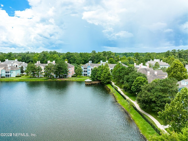 birds eye view of property with a water view and a residential view