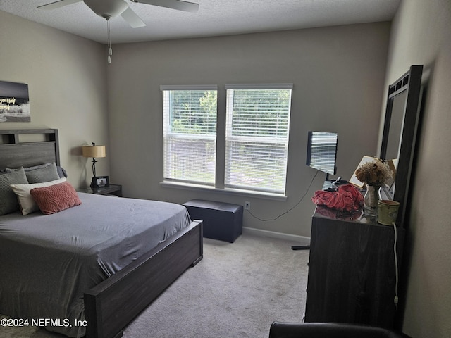 bedroom with a ceiling fan, baseboards, and carpet flooring