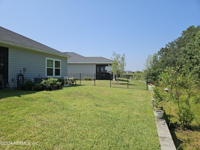 view of yard featuring cooling unit and fence