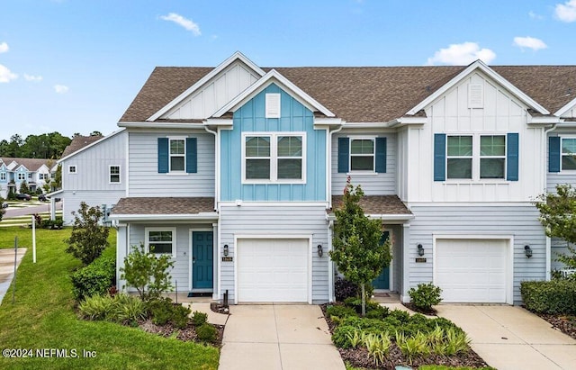 townhome / multi-family property featuring a front lawn and a garage