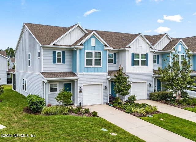 view of property with a garage and a front lawn