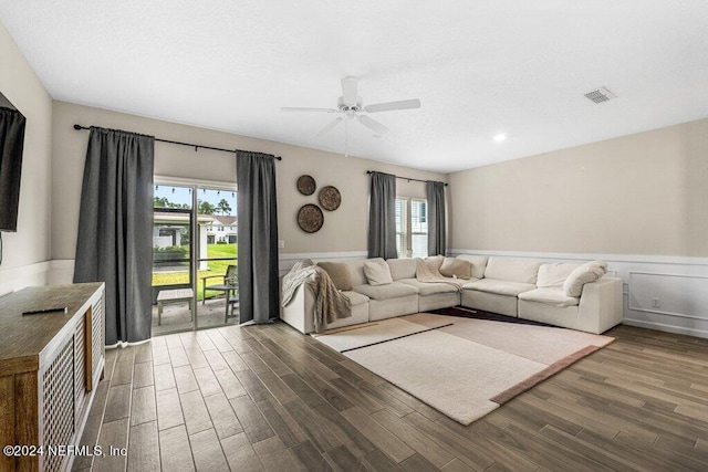 unfurnished living room with ceiling fan, wood-type flooring, and plenty of natural light