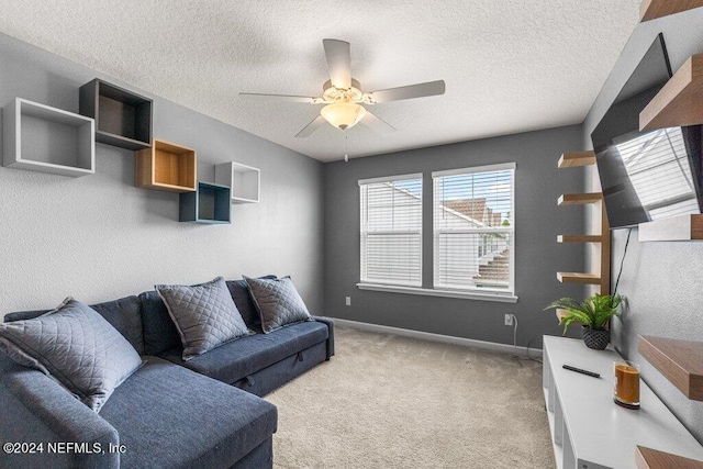 carpeted living room featuring ceiling fan and a textured ceiling