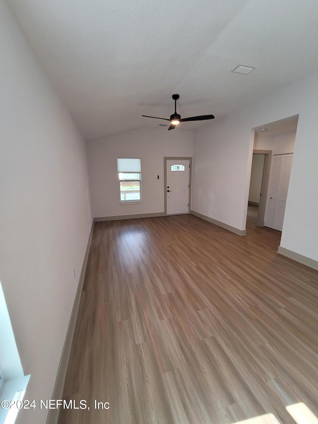 unfurnished living room featuring ceiling fan, hardwood / wood-style flooring, and lofted ceiling