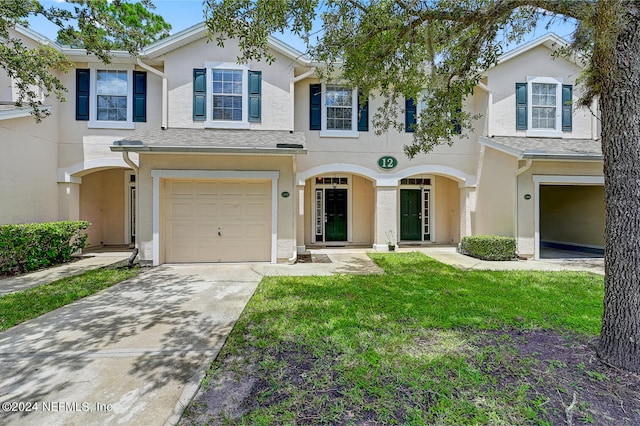 view of front of property featuring a garage and a front yard