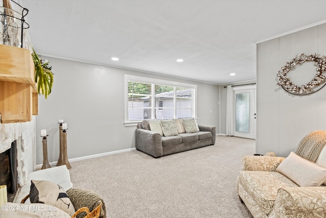 living area with ornamental molding, a premium fireplace, and carpet flooring