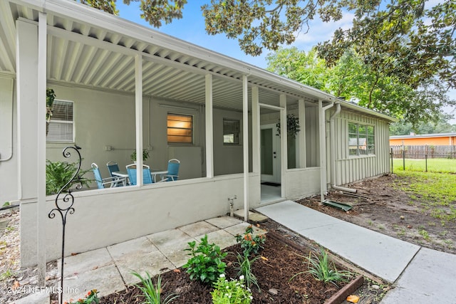 exterior space with board and batten siding and fence