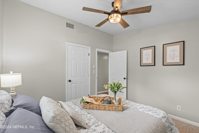 bedroom with carpet, visible vents, ceiling fan, and baseboards