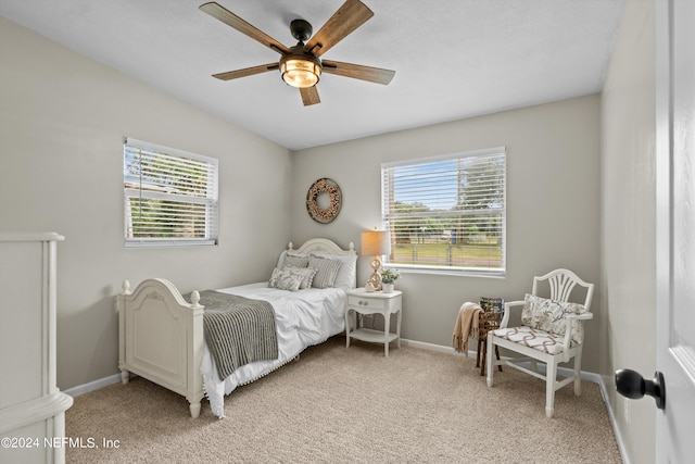 bedroom with baseboards, ceiling fan, and light colored carpet