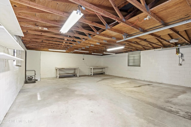 basement featuring a garage and concrete block wall