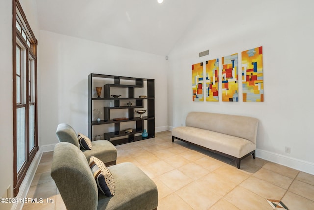 living room with tile patterned flooring, vaulted ceiling, and a wealth of natural light