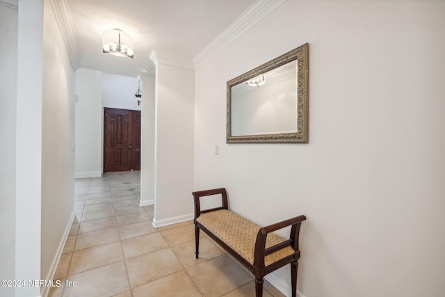 hall with crown molding, a textured ceiling, and light tile patterned floors