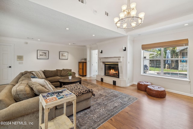 living room with hardwood / wood-style flooring, crown molding, and a premium fireplace