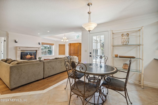 dining area with crown molding and light tile patterned flooring