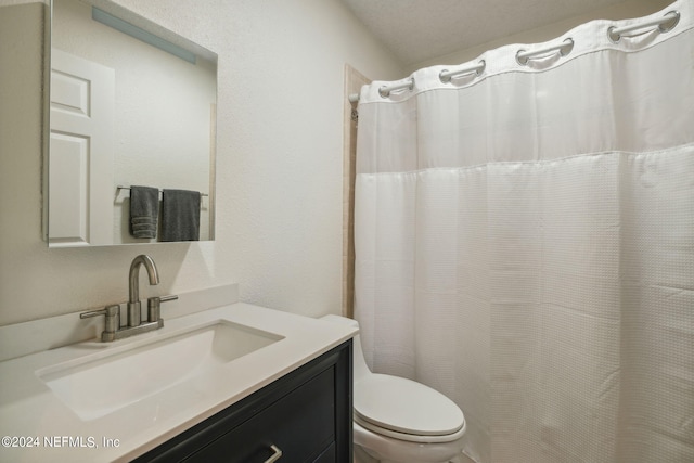 bathroom with vanity, walk in shower, and toilet