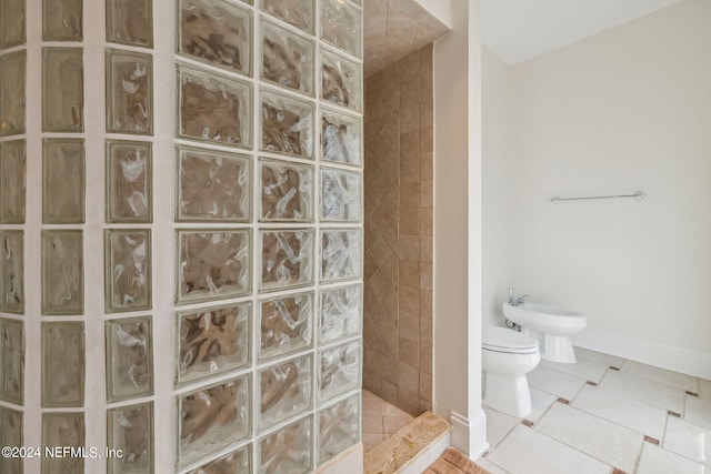 bathroom featuring a bidet, tile patterned flooring, and tiled shower