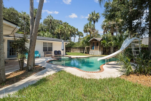 view of pool with an in ground hot tub and a water slide