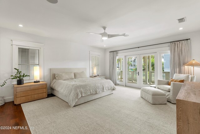 bedroom with access to exterior, ceiling fan, french doors, and dark hardwood / wood-style flooring