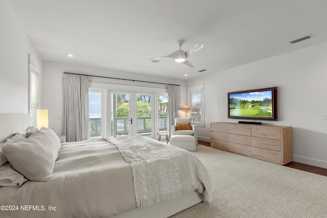 bedroom with hardwood / wood-style floors, ceiling fan, access to outside, and french doors