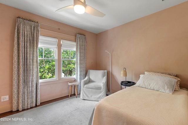 bedroom featuring ceiling fan and carpet