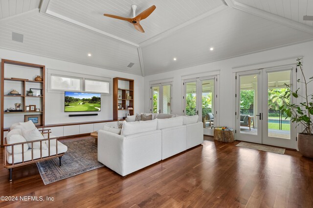 living room with a healthy amount of sunlight, vaulted ceiling with beams, ceiling fan, and french doors