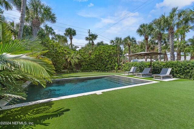 view of swimming pool with a lawn and a patio area