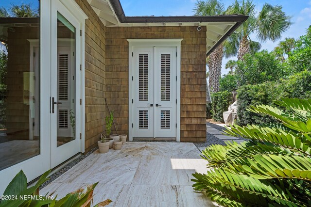 wooden deck with french doors and a patio