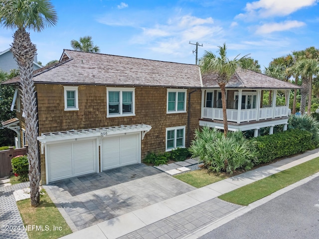 view of front of house with an attached garage and decorative driveway