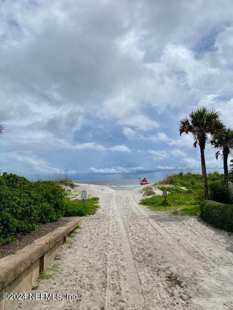 view of street with a beach view and a water view